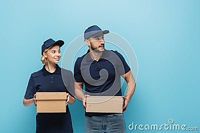 interracial couriers holding parcels and smiling Stock Photo