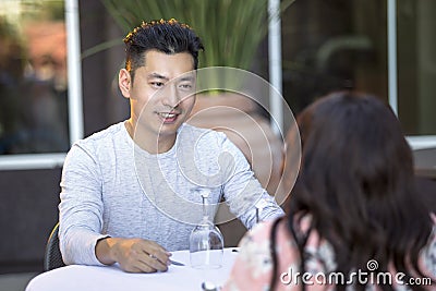 Handsome Asian Male on a Date with a Female Outdoors Stock Photo