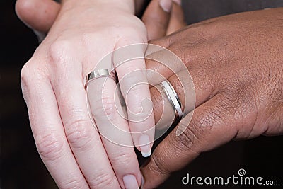 Interracial hands with wedding rings Stock Photo