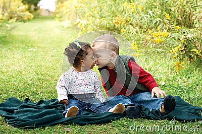 Interracial toddlers showing affection. Fight racism Stock Photo