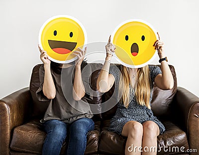 Interracial women holding an expressive emoticons Stock Photo