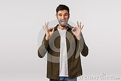 Interview went well, was excellent. Pleased confident and optimistic modern bearded guy show okay, approval or ok sign Stock Photo