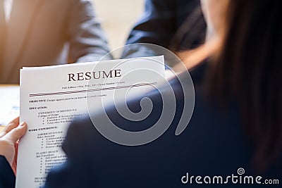 Interviewer reading a resume, Person submits job application, Person describe yourself to interviewer, Close up view of job Stock Photo