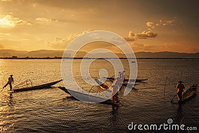 Intha Burmese fishermen on boat catching fish traditional at Inle Lake Editorial Stock Photo