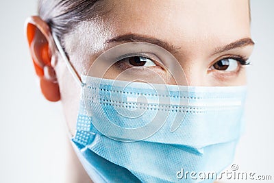 Intimate closeup portrait of attractive caucasian young woman wearing protective face mask Stock Photo
