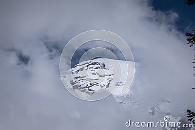 Keyhole view through Clouds of the Majestic Mt. Ranier Stock Photo