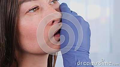 Intra oral neuromuscular massage. Female professional beautician makes facial massage to herself, close up Stock Photo