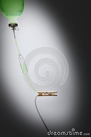 Intravenous drip with wooden peg clipping on its tube. Conceptual image Stock Photo