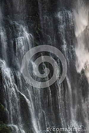 An intricate and close-up view of waterfall cascades, where water splashes and flows down rock faces, creating a dynamic visual Stock Photo