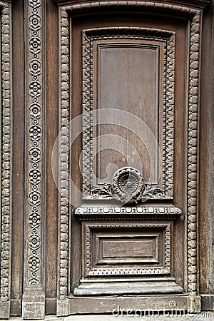 Intricate detail in carvings on face of old wood door Stock Photo