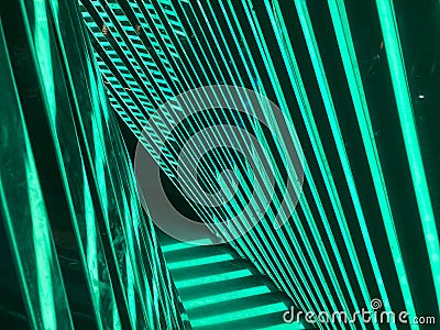 Intricate, light-based art installation with intersecting green neon tubes Showcases dynamic patterns against a dark Stock Photo