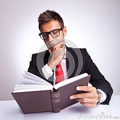 Intrigued business man reading a book Stock Photo