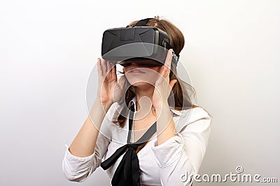 Intrigued woman in a white formal shirt, wearing Oculus Rift VR Virtual reality 3D headset, exploring the play; Editorial Stock Photo