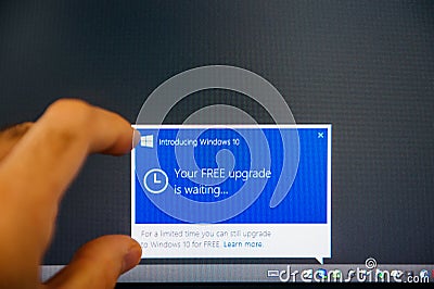 Introducing Windows 10 message on computer display man touching Editorial Stock Photo