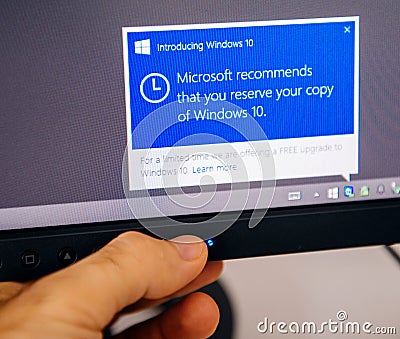 Introducing Windows 10 message on computer display man touching Editorial Stock Photo