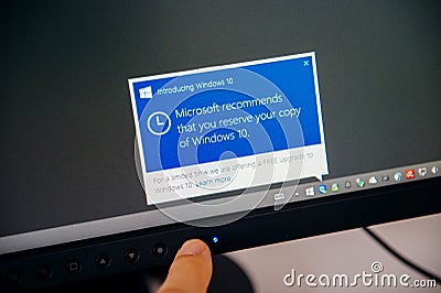 Introducing Windows 10 message on computer display man touching Editorial Stock Photo