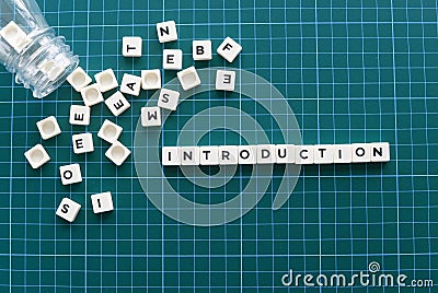 Introduction word made of square letter word on green background. Stock Photo