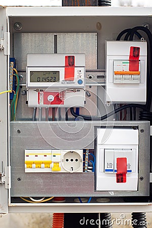 An introductory machine and an electric energy meter in a dashboard on a pole close-up Stock Photo