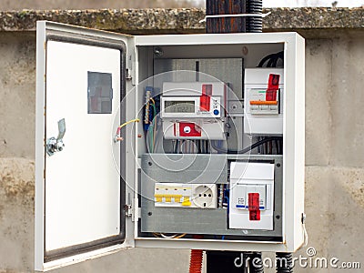 Introductory machine and electric energy meter in a dashboard on a pole on a land plot Stock Photo