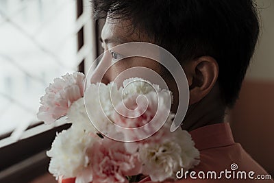 Introspective Asian Gay and His Flowers Stock Photo