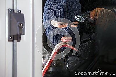 Intruder with crow bar and hand gun Stock Photo