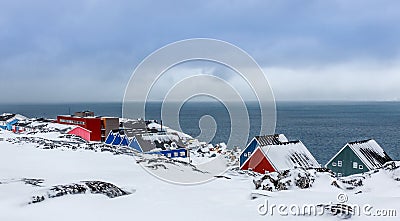 Inuit village houses covered in snow at the fjord of Nuuk city, Greenland Stock Photo