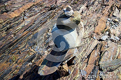 Inukshuk on rocky Nova Scotia, Canada coastline Stock Photo