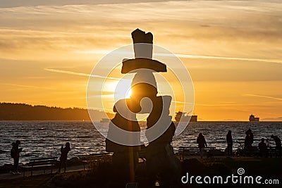 Inukshuk stone sculpture in the sunset time at English Bay Beach, Vancouver City, Canada. Editorial Stock Photo