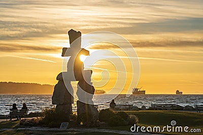 Inukshuk stone sculpture in the sunset time at English Bay Beach, Vancouver City, Canada. Editorial Stock Photo