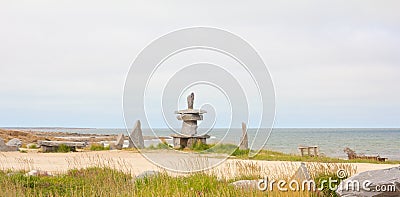 Inuksuk at the shore Stock Photo