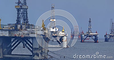 Invergordon decommissioned jackup rigs path the way to the port Stock Photo