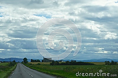 A thick cover of clouds over a highway in the Highlands of Scotland Stock Photo