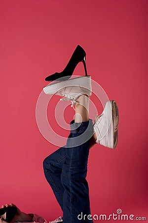 inverted foot black shoe fashion modern style pink background Stock Photo