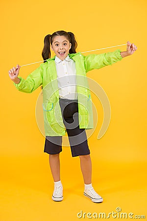 Invest in durable kids rainwear to keep children out in fresh air. Waterproof concept. Small schoolgirl wear water Stock Photo