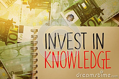 Invest In Knowledge. copybook page put on 100 Euro banknotes. Business concept Stock Photo