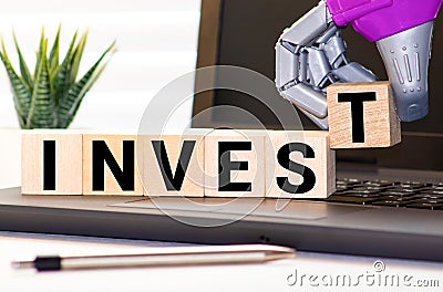 invest word written on wood block Stock Photo