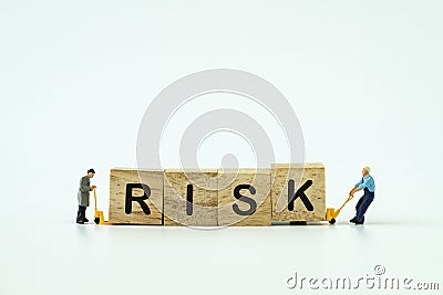 Investement Risk management concept with miniature workers small Stock Photo