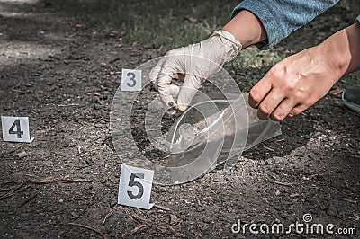 Investigator collects evidence - crime scene investigation Stock Photo