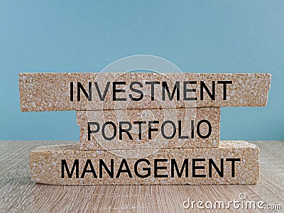 Investment portfolio management symbol. Concept words Investment portfolio management on brick blocks. Beautiful blue background. Stock Photo