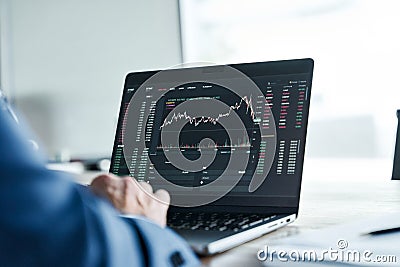 Investor analyst analyzing crypto stock market on computer screen. Over shoulder Stock Photo