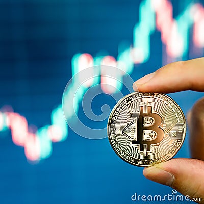 Investor hand holding silver Bitcoin Stock Photo