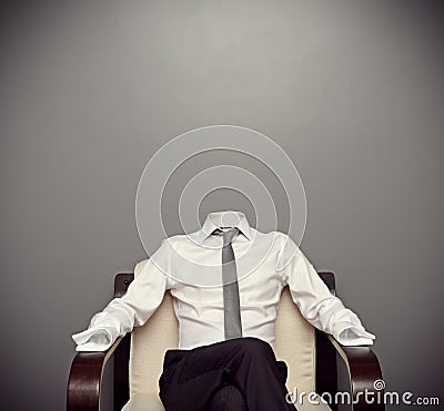 Invisible man sitting on armchair Stock Photo