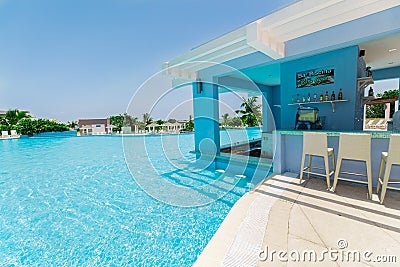 inviting view of two level swimming pool, bar and grounds at Grand Aston hotel, resort Editorial Stock Photo