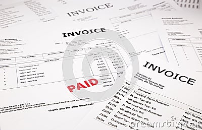 Invoices and bills with paid stamp Stock Photo