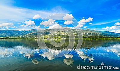 Ioannina lake Pamvotida in Epirus Region, Greece. Artistic panoramic view with natural reflection in the water Stock Photo