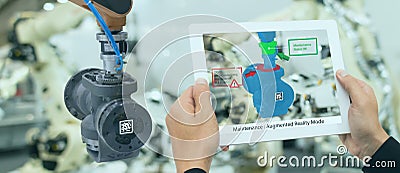 Iot industry 4.0 concept,industrial engineer using smart tablet with augmented mixed with virtual reality technology to monitoring Stock Photo