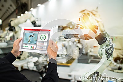 Iot industry 4.0 concept,industrial engineer using software augmented, virtual reality in tablet to monitoring machine in real t Stock Photo