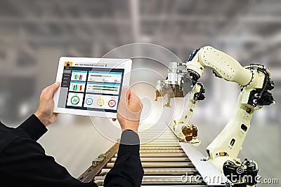 Iot industry 4.0 concept,industrial engineer using software augmented, virtual reality in tablet to monitoring machine in real t Stock Photo