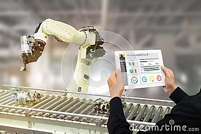 Iot industry 4.0 concept,industrial engineer using software augmented, virtual reality in tablet to monitoring machine in real t Stock Photo