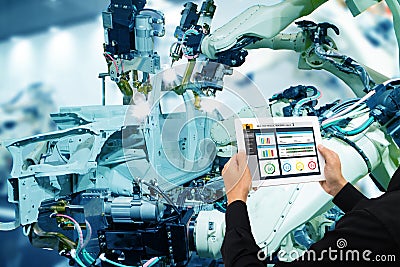 Iot industry 4.0 concept,industrial engineer using software augmented, virtual reality in tablet to monitoring machine in real t Stock Photo